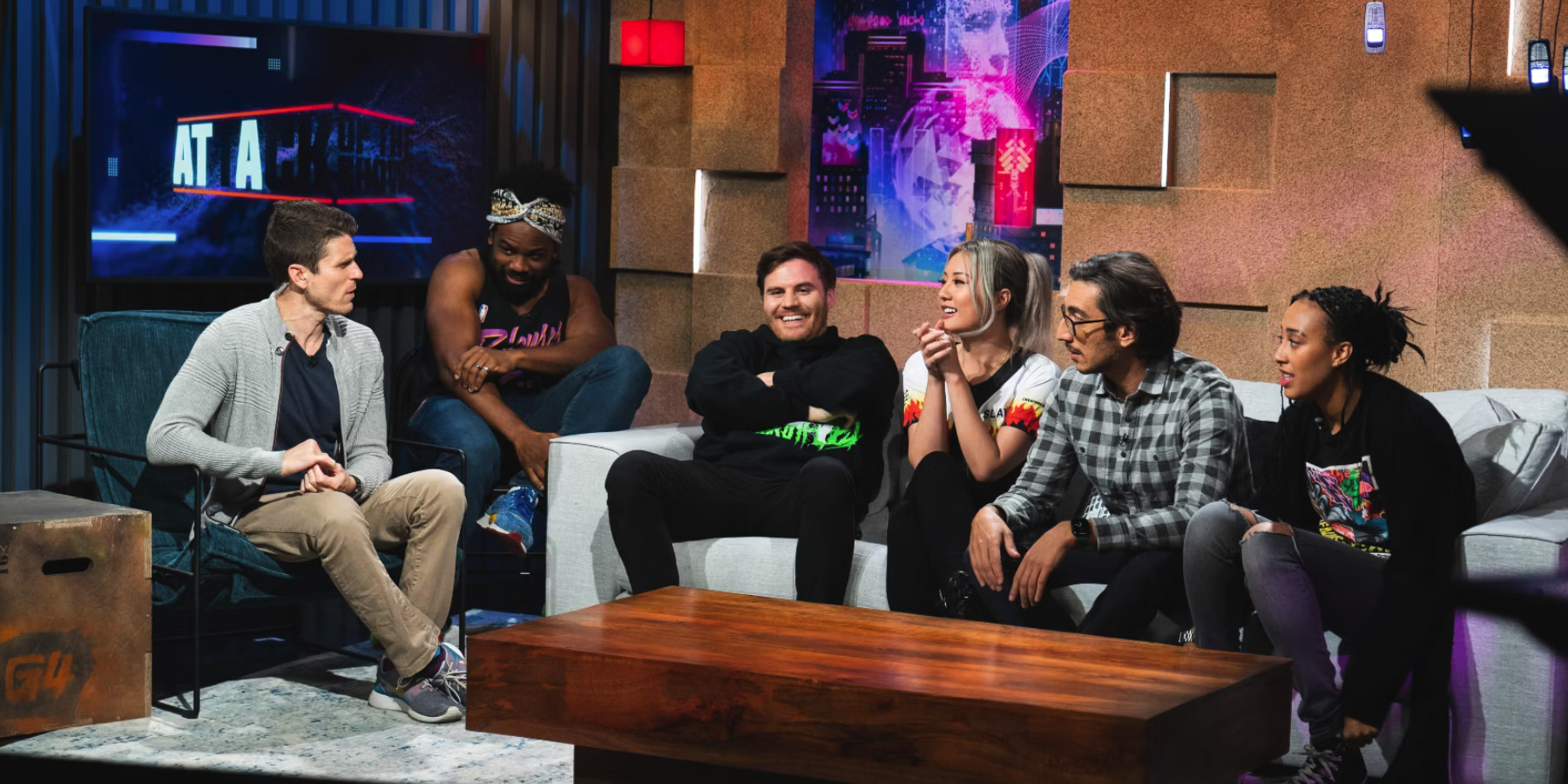 Hosts of Attack of the Show sitting around a table talking to each other